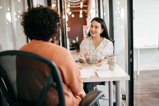 Two office workers having effective communication in the workplace